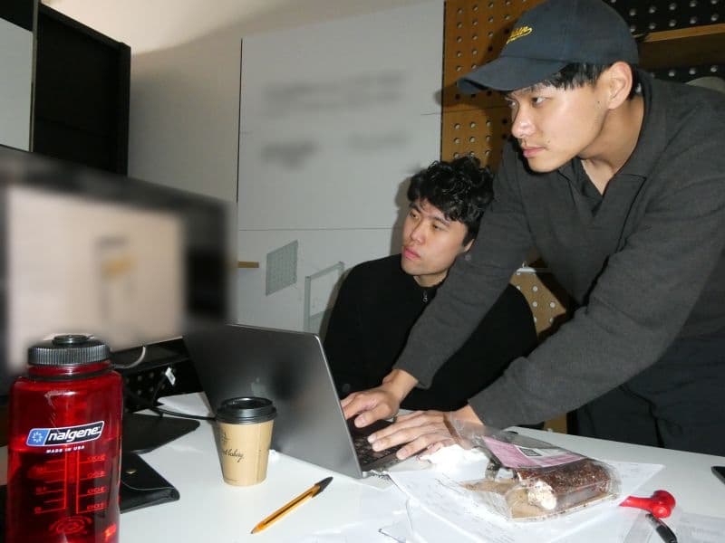 Two purpl developers working through a build on a laptop